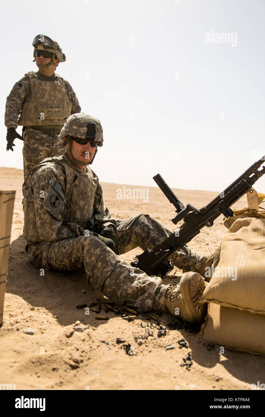 Soldiers from 3rd Battalion, 238th General Support Aviation Battalion (GSAB), and 3rd Battalion, 142nd Assault Helicopter Battalion (AHB), shoot the first phase of aerial gunnery with a 240B machine gun on June 3, 2014, near Camp Buehring, Kuwait.  Once refreshed with the weapon system on the ground the aviators of the battalions will conduct aerial gunnery training and qualifications with their UH-60 Black Hawks later on in the month.  The GSAB and AHB, from the Michigan and New York Army National Guards, respectively, are both deployed to Kuwait under the 42nd Combat Aviation Brigade in supp Stock Photo