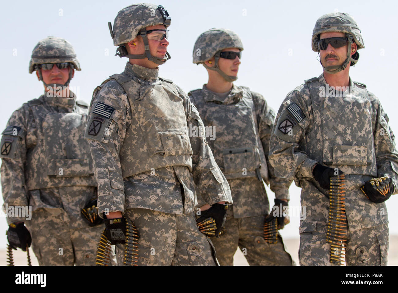 Soldiers from 3rd Battalion, 238th General Support Aviation Battalion (GSAB), and 3rd Battalion, 142nd Assault Helicopter Battalion (AHB), wait with their amunition before the first phase of aerial gunnery with a 240B machine gun on June 3, 2014, near Camp Buehring, Kuwait.  Once refreshed with the weapon system on the ground the aviators of the battalions will conduct aerial gunnery training and qualifications with their UH-60 Black Hawks later on in the month.  The GSAB and AHB, from the Michigan and New York Army National Guards, respectively, are both deployed to Kuwait under the 42nd Comb Stock Photo