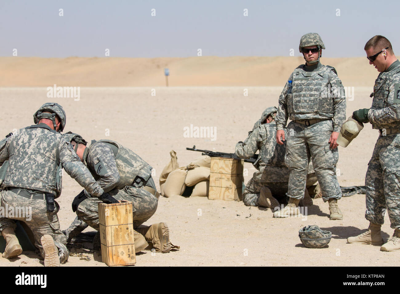 Soldiers from 3rd Battalion, 238th General Support Aviation Battalion (GSAB), and 3rd Battalion, 142nd Assault Helicopter Battalion (AHB), shoot the first phase of aerial gunnery with a 240B machine gun on June 3, 2014, near Camp Buehring, Kuwait.  Once refreshed with the weapon system on the ground the aviators of the battalions will conduct aerial gunnery training and qualifications with their UH-60 Black Hawks later on in the month.  The GSAB and AHB, from the Michigan and New York Army National Guards, respectively, are both deployed to Kuwait under the 42nd Combat Aviation Brigade in supp Stock Photo