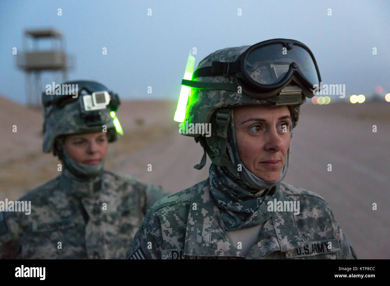 Sgt. First Class Joann Duclose (front), a senior human resources sergeant, and Master Sgt. Cindy Marcinkowski, the operations NCOIC, both from the 642nd Aviation Support Battalion, wait for nightfall before starting sling load training with aviators from 3rd Battalion, 142nd Assault Helicopter Battalion, on June 5, 2014, in Camp Buehring, Kuwait.  The 642nd and 142nd, both under the 42nd Combat Aviation Brigade, New York Army National Guard, are deployed to Kuwait in support of Operation Enduring Freedom. (N.Y. Army National Guard photo by Sgt. Harley Jelis/Released) Stock Photo