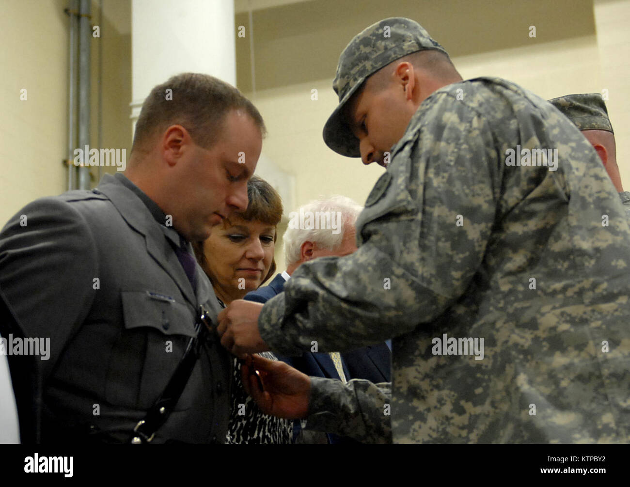 SYRACUSE, NYNew York State Trooper Joseph Krywalski, left, receives