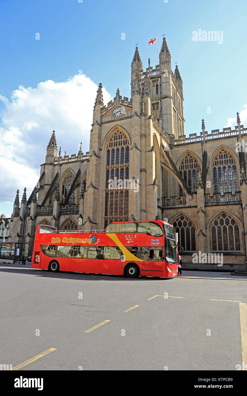 Double deck tourist bus parked outside Bath Abbey, Bath Stock Photo