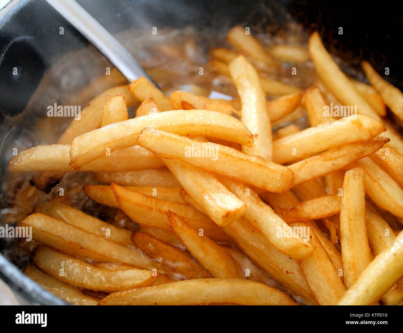 Golden brown crispy french fries cooking in deep fryer Stock Photo Alamy
