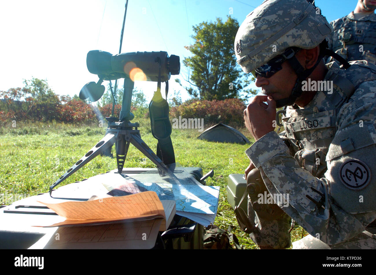 100918-A-T5311-0007.jpg – Staff Sgt. Onix Lugo, platoon sergeant for the  target acquisition section, Headquarters Battery, 1-258 Field Artillery  Battalion, New York Army National Guard, reviews a map of the impact zone  and