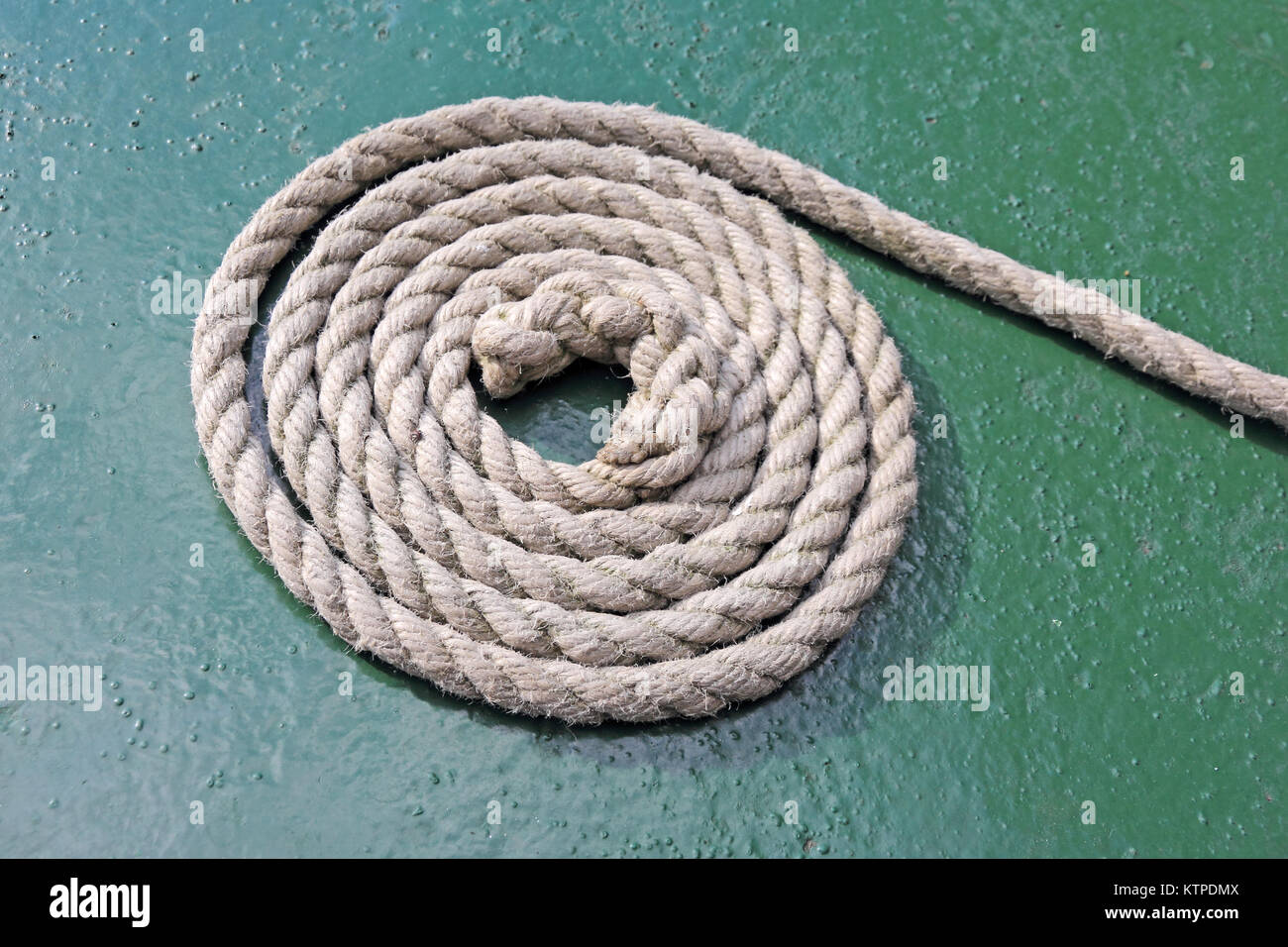 Rope neatly coiled on boat Stock Photo