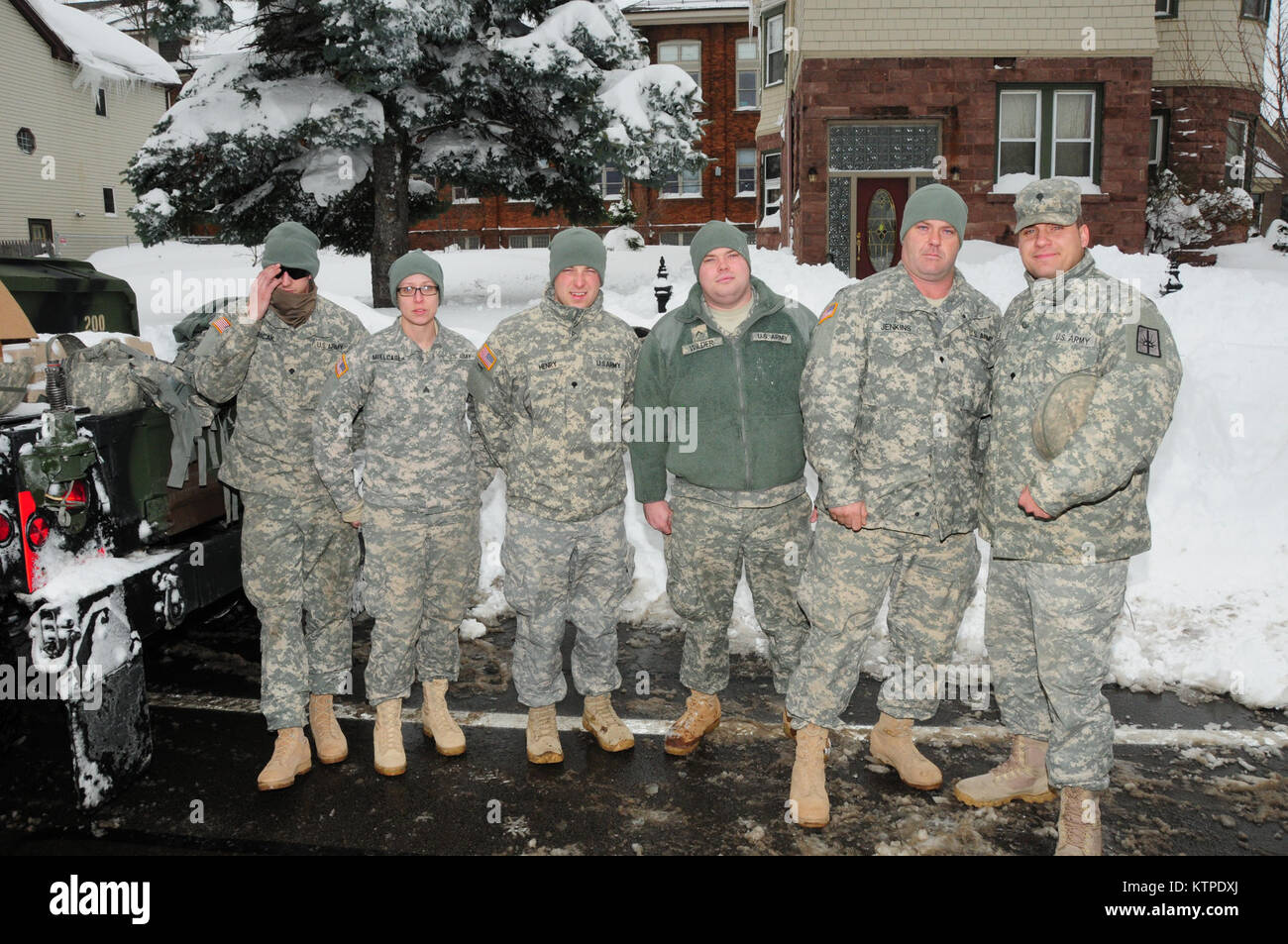 New York Army National Guard Soldiers from the 152nd Engineer Company use engineering equipment to assist in snow removal efforts in West Seneca, N.Y., just east of Buffalo November 20 as part of Governor Andrew Cuomo’s callup of some 375 National Guard members to support response and recovery efforts in Western New York following historic amounts of snowfall. Some two dozen engineers, based in Buffalo, utilized bucket loaders and dump trucks to clear key roadways for emergency responders at this one site, part of ongoing efforts with more than a dozen missions completed in the first 48 hours. Stock Photo