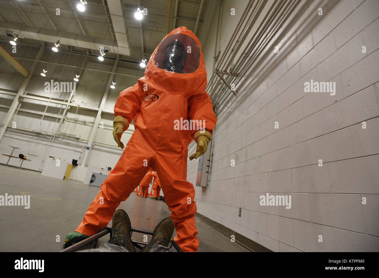 PERRY, GA - Master Sergeant Brian Silsbee, an Emergency Manager from the 149th Fighter Wing, carries a simulated casualty during an exercise on the first day of Global Dragon on March 9, 2015.   Through the first set of scenerios, airman trained in Level A Hazardous Material suits, using their equipment to test for chemical, biological, radiological and nuclear (CBRN)  contamination. The training emphasized coordination within small teams, with each airman working to support their wingman to accomplish the mission.   Exercise Global Dragon is a two-week long course taking place at the Guardian Stock Photo