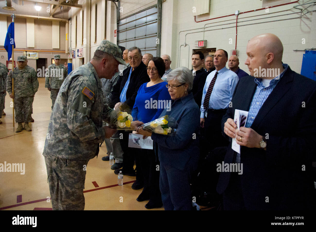 Sgt. 1st Class Dave Travers presents flowers to the mother of Lt. Col