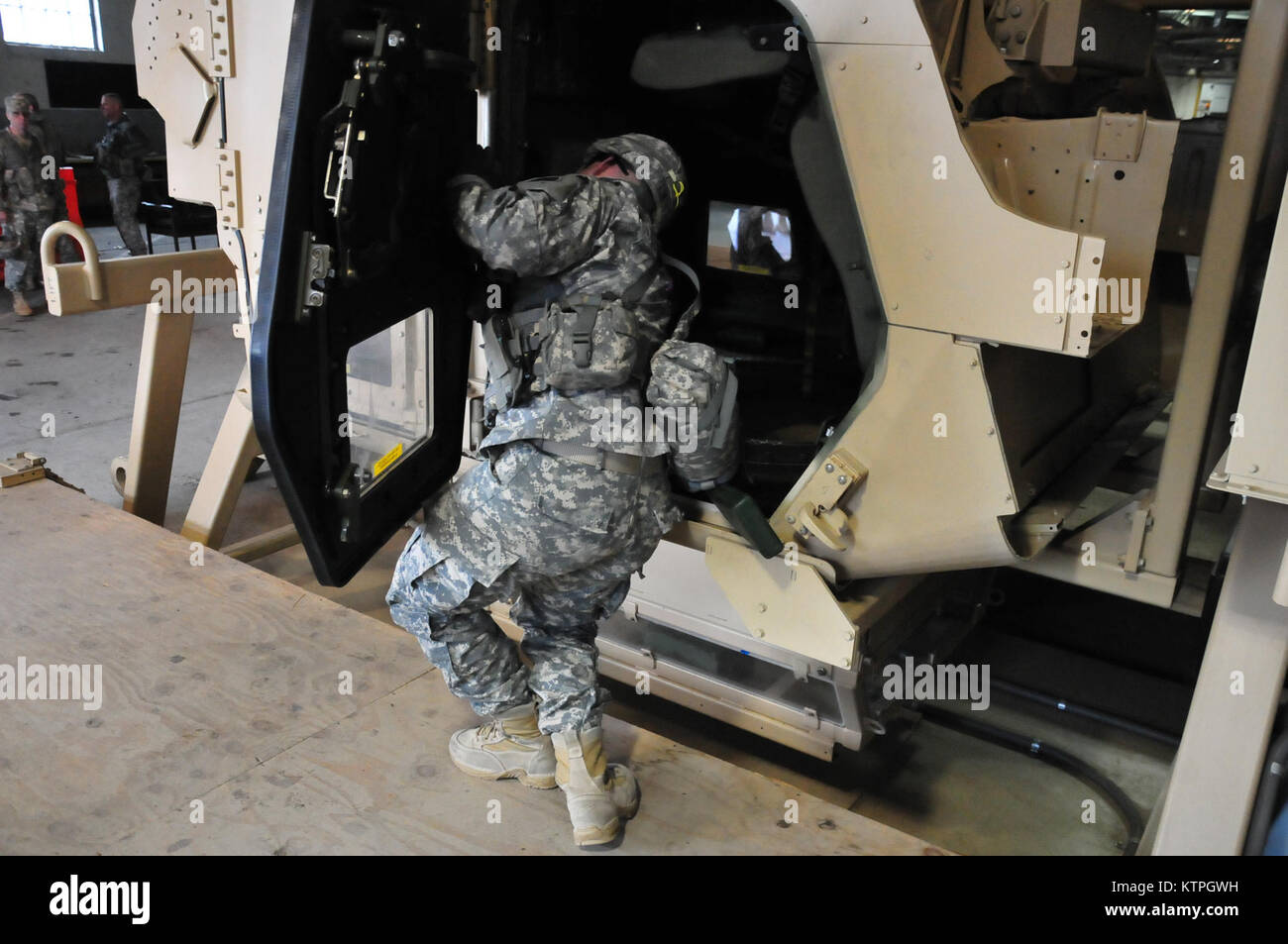 A 42nd Inf. Div. Soldier manuvers his way out of the HEAT rollover