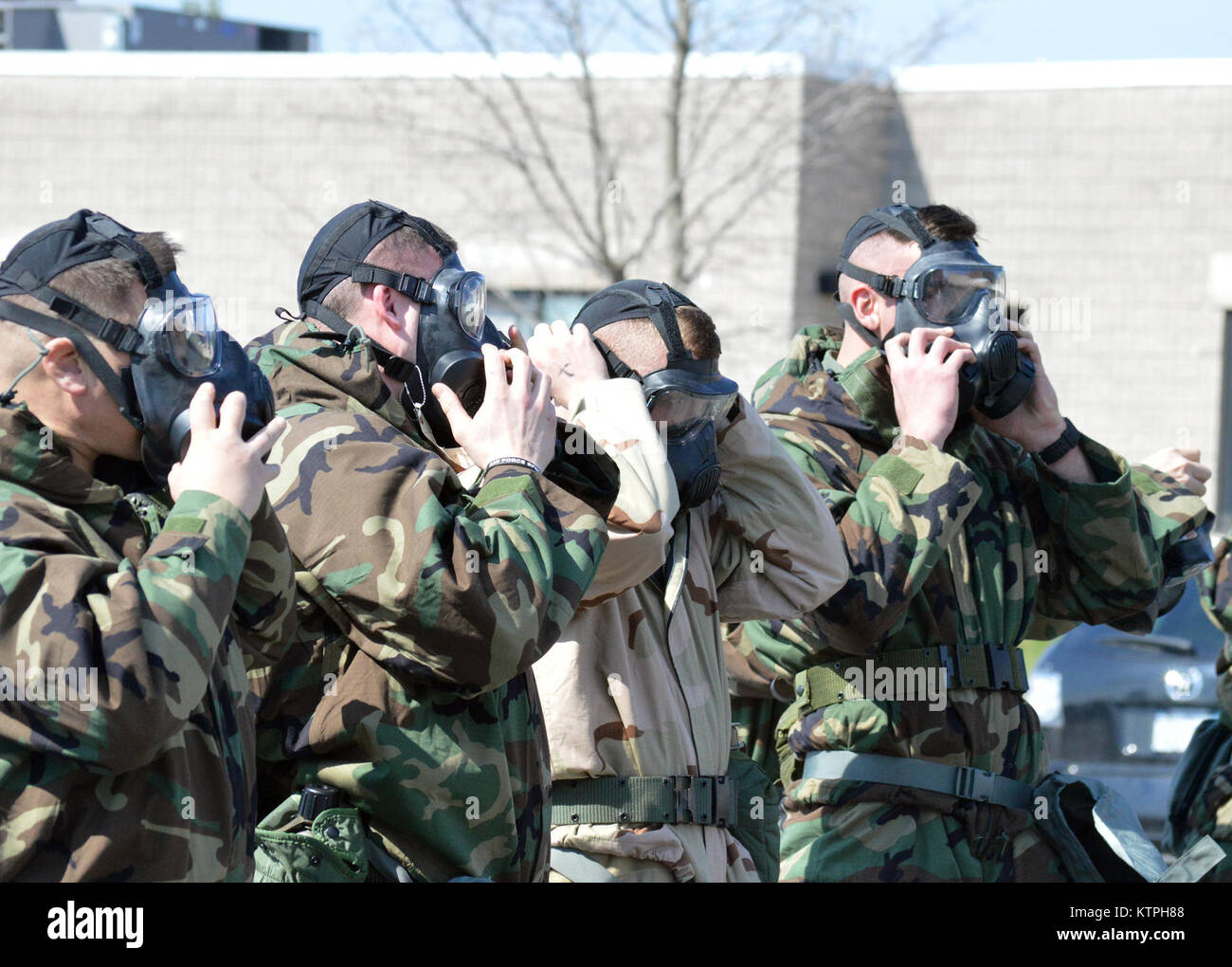 Airmen don their masks during the hands-on chemical, biological, radiological and nuclear training at Stratton Air National Guard Base, New York, on April 18, 2015. The training was part of the 109th Airlift Wing's first ancillary training rodeo where more than 200 Airmen were trained on CBRN as well as self-aid and buddy care. (U.S. Air National Guard photo by Tech. Sgt. Catharine Schmidt/Released) Stock Photo