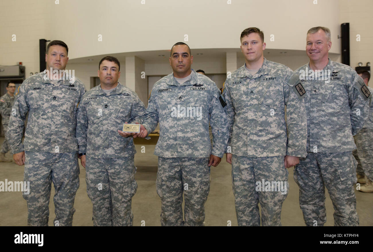Sgt. 1st Class Brian Manny, Sgt. 1st Class Robert Landry, Staff Sgt. Ramon Rodriguez, and Sgt. John Kolach, of Joint Force Headquarters, pose with Brig. Gen. Michael Swezey after receiving 1st place for the team rifle match at the annual New York TAG Combat Sustainment Training Exercise on May 31, 2015, at Camp Smith, N.Y.  The exercise is an annual three day event that tests individuals and teams against each other in rifle and pistol shooting matches. (N.Y. Army National Guard photo by Sgt. Harley Jelis/ Released) Stock Photo