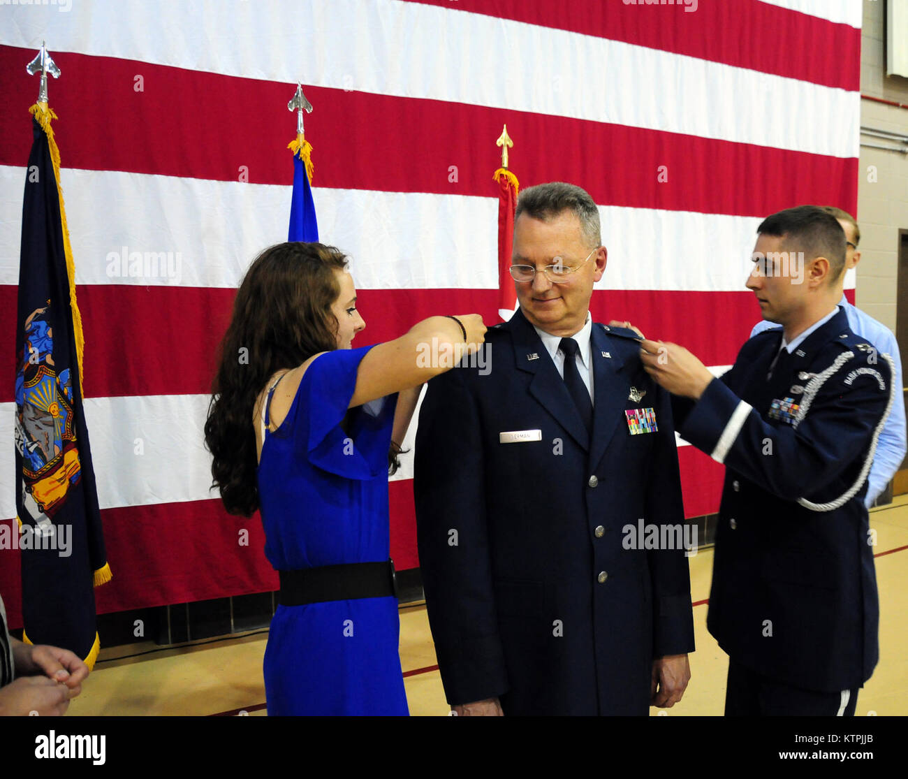LATHAM-- New York Air National Guard Major General Anthony German, the commander of the 5,900-member New York Air National Guard receives his two-star rank from his daughter Beckah (left) and son Air National Guard Captain  Joshua German during his promotion and change-of-command ceremony at New York State Division of Military and Naval Affairs headquarters on Monday, June 22, 2015, ( U.S. Army National Guard photo by Sgt. 1st Class Steven Petibone/released) Stock Photo