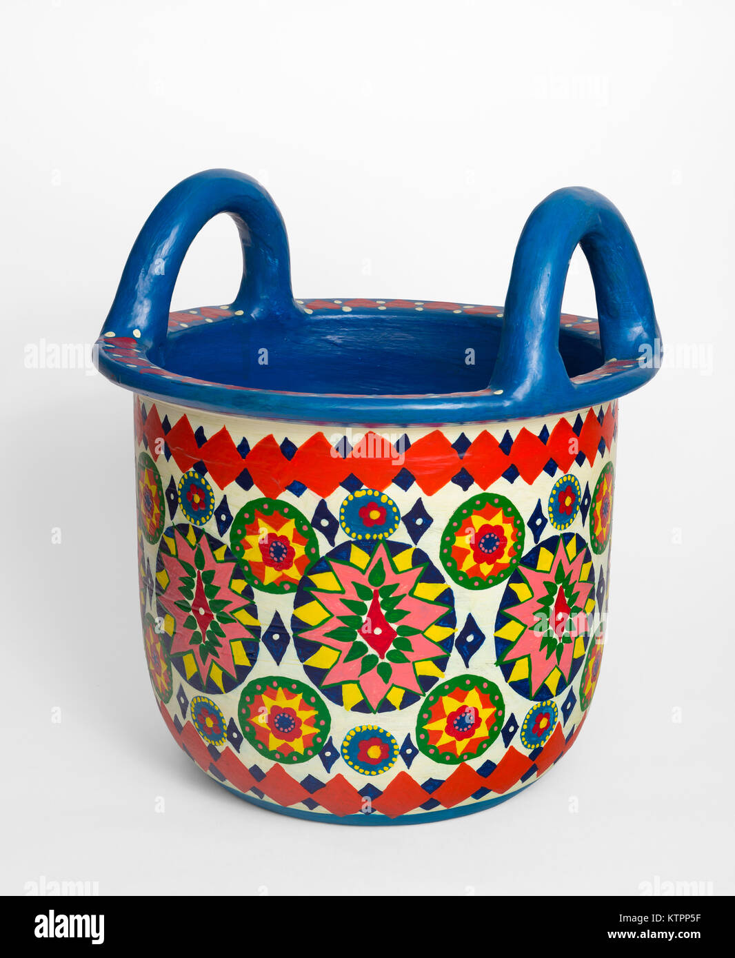 Handmade artistic pained colorful decorated pottery basket with two handles on white background