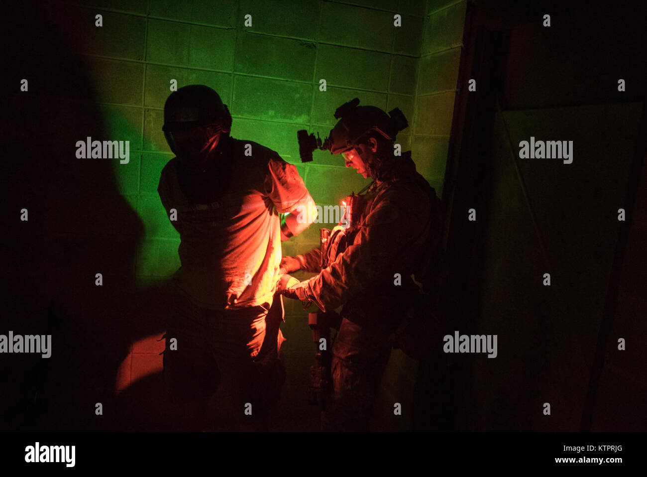 Special Forces personnel identify, treat and process rescued hostages during a noncombatant evacuation exercise at Meridian Naval Air Station, Mississippi Nov. 3, 2015.  Rescue personnel arrived by helicopter to the mock embassy, engaged enemy forces and rescued personnel being held hostage.  This training event allowed  U.S. Army and Air Force to train military members, refine planning and help prepare noncombatants such as U.S. military dependents as well as DoD civilians and their families in the event of a full-scale evacuation order from the U.S. Department of State.  Exercise Southern St Stock Photo