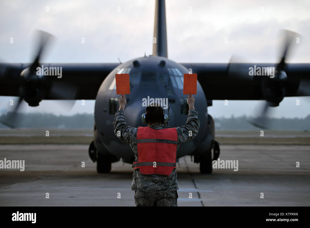 Staff Sgt. Cory Shwartz, an airman with the New York Air National Guard's 106th Rescue Wing, guides in an HC-130 Hercules aircraft with the 102nd Rescue Squadron at the Combat Readiness Training Center in Gulfport, Miss., during Exercise Southern Strike 16, Nov. 5, 2015.  The exercise emphasizes air-to-air, air-to-ground and special forces training opportunities.  (New York Air National Guard / Staff Sergeant Christopher S Muncy / released) Stock Photo