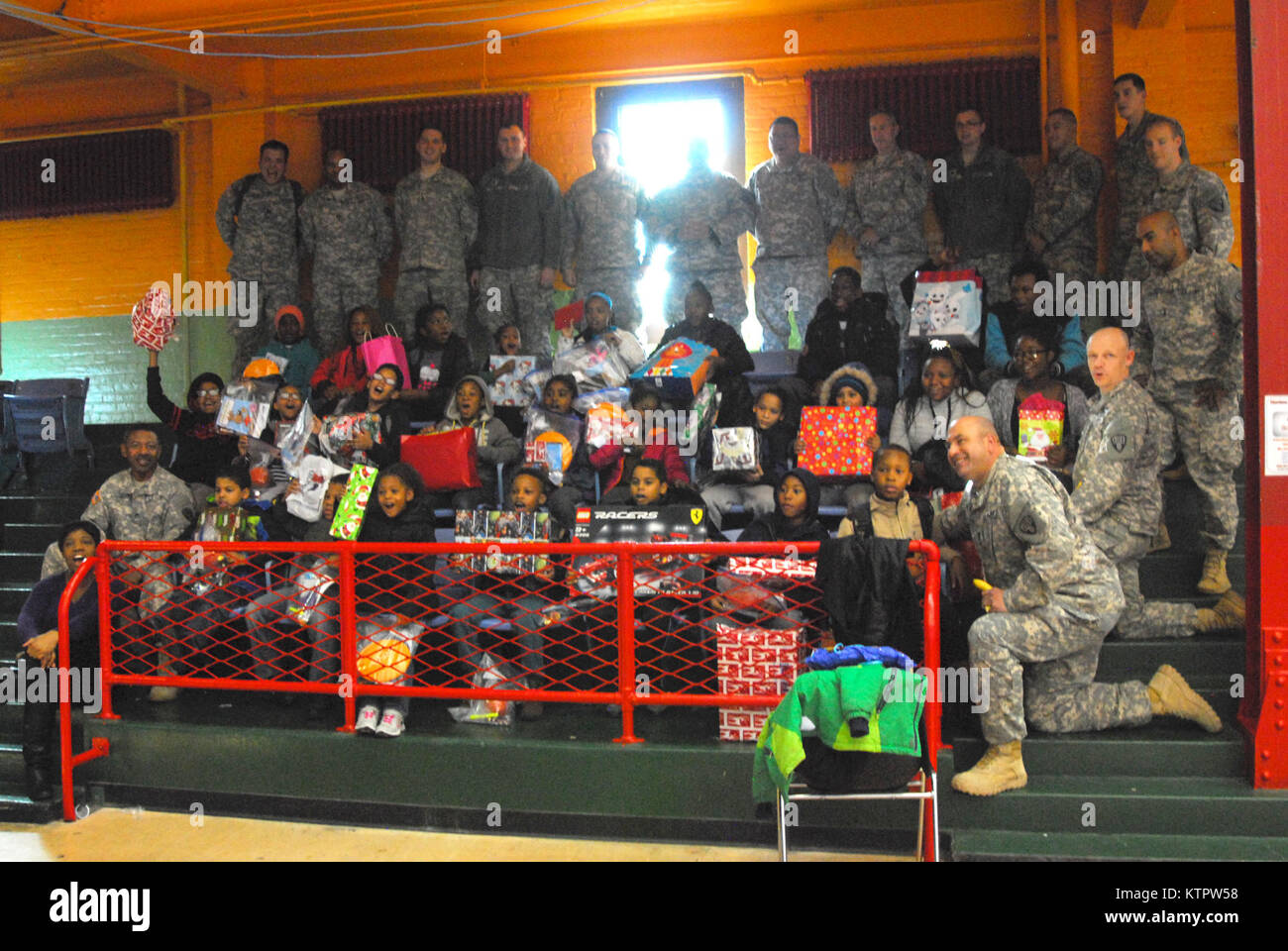 Soldiers of the 369th Sustainment Brigade pose with children from the