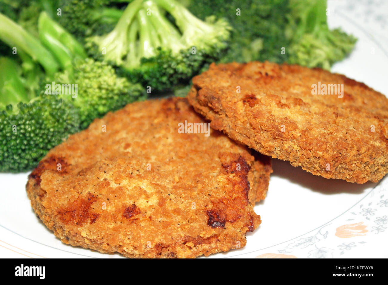 Crispy breaded chicken patties with fresh broccoli Stock Photo Alamy