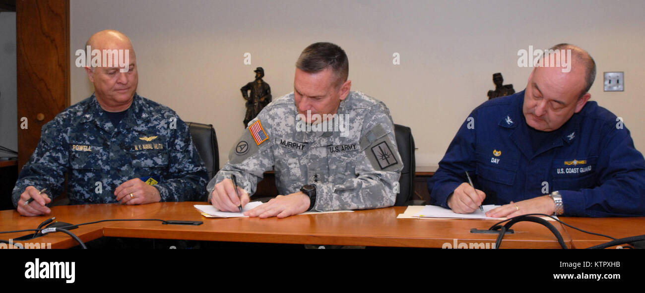 LATHAM, N.Y. – Adjutant General of New York Maj. Gen. Patrick Murphy (center), Rear Adm. Ten Eyck Powell III, the New York State Naval Militia commander (left), and United States Coast Guard Capt. Michael Day (right), the captain of the port of New York, sign a joint-use agreement at the New York State Division of Military and Naval Affairs here on March 8, 2016. The agreement ensures that the New York State Naval Militia and Coast Guard can continue working together to secure the waterways around New York City. (U.S. Army National photo by Master Sgt. Raymond Drumsta/released) Stock Photo