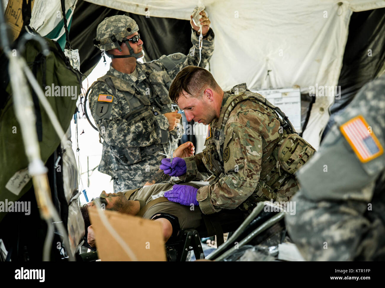 New York Army National Guard medics, assigned to Headquarters Co., 1st Battalion, 69th Infantry, triage a Soldier during a mass casualty exercise at the Army’s Joint Readiness Training Center, Fort Polk, La., Saturday, July 16, 2016. More than 3,000 New York Army National Guard Soldiers deployed for a three week exercise at the Army’s Joint Readiness Training Center, July 9-30, 2016. U.S. Army National Guard photo by Sgt. Harley Jelis. Stock Photo