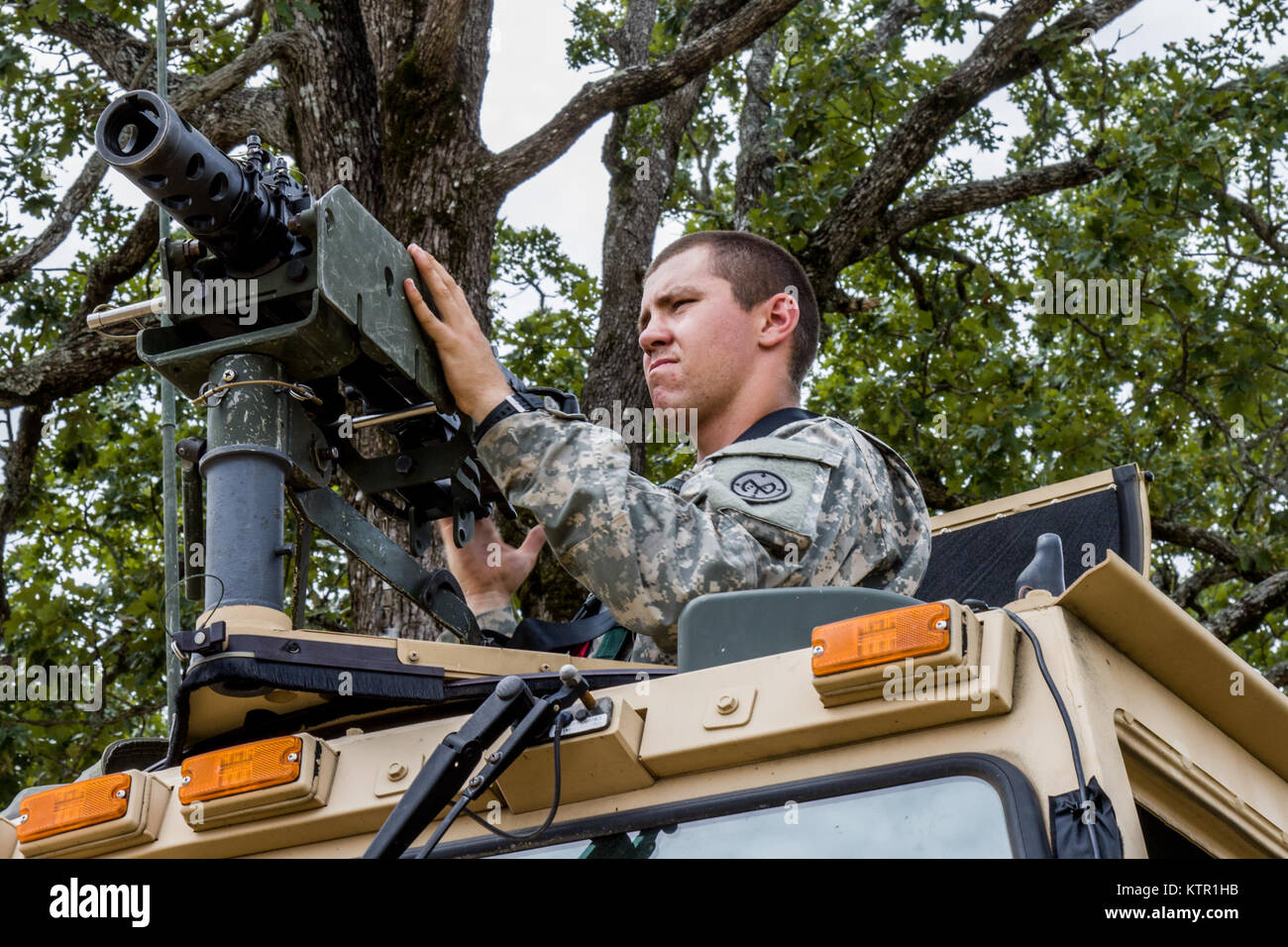New York Army National Guard Private 1st Class Tyler Miner, an infantryman with the 2nd Battalion, 108th Infantry, installs an M2 .50 caliber machine gun to the roof of a tactical vehicle at the Army’s Joint Rotational Training Center, Ft. Polk, La., July 16, 2016.   More than 3,000 New York Army National Guard Soldiers deployed to Fort Polk, Louisiana for a three-week exercise at the Army’s Joint Readiness Training Center, July 9-30, 2016. (U.S. Army National Guard photo by Sgt. Michael Davis) Stock Photo