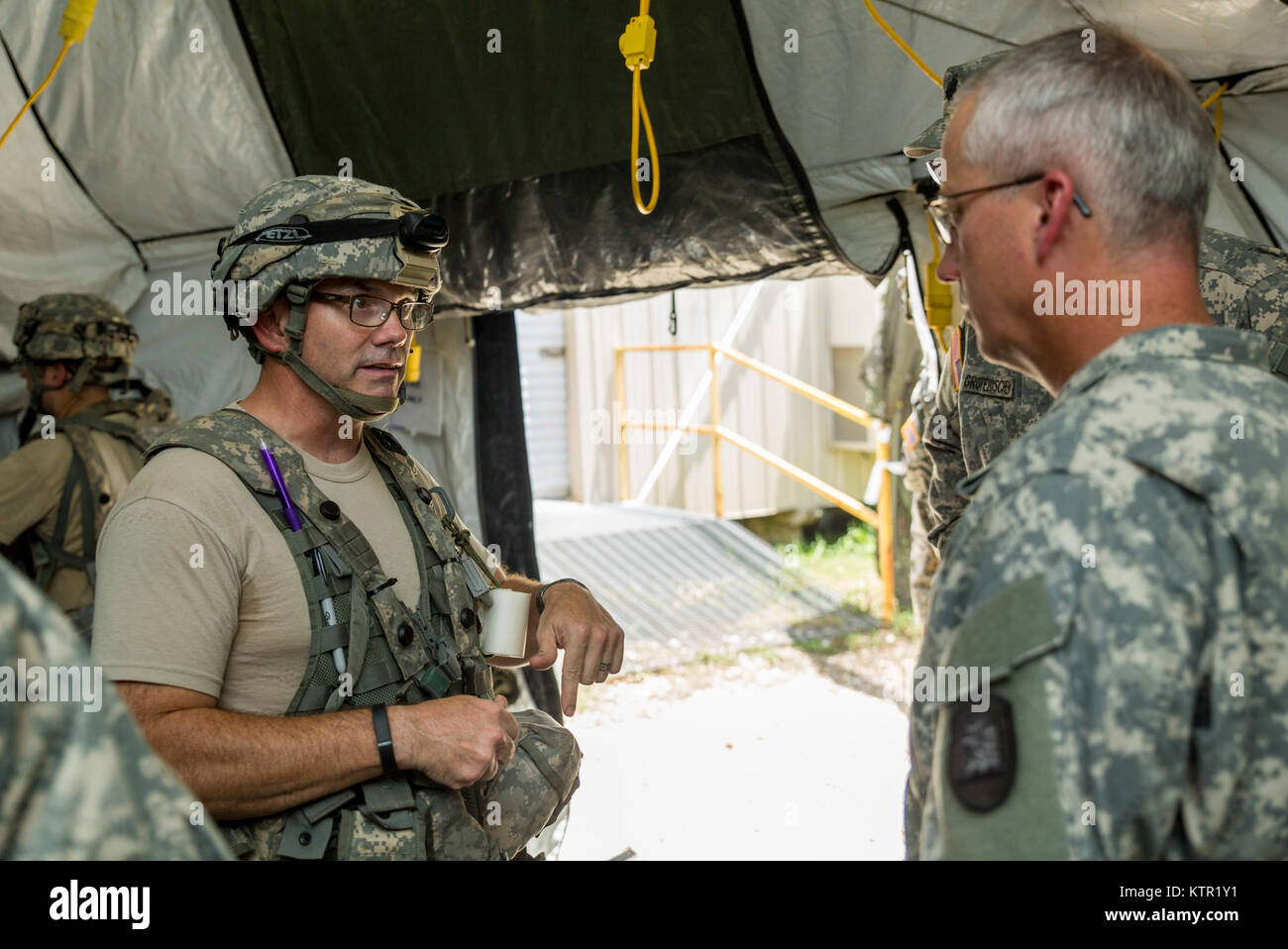 A Soldier with the 209th Area Support Medical Company, Iowa Army National Guard, speaks to Col. Jaime Dailey, commander of 67th Troop Command, during the unit's Joint Readiness Training Center (JRTC) rotation July 19, 2016, in Fort Polk, La.  The Iowa medical personnel joined more than 5,000 Soldiers from other state Army National Guard units, active Army and Army Reserve troops as part of the 27th Infantry Brigade Combat Team task force.  The Soldiers will hone their skills and practice integrating combat operations ranging from infantry troops engaging in close combat with the enemy to artil Stock Photo