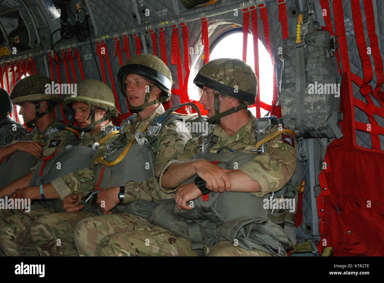 U.S. Army and Partner Nation Paratroopers jump from a  CH-47 F Chinook Helicopter operated by the New York Army National Guard's Co. B 3rd Battalion 126th Aviation during Leapfest 2016 at the University of Rhode Island, West Kingston, R.I., August 6, 2016. Leapfest is the largest, longest standing, international static line parachute training event and competition hosted by the 56th Troop Command, Rhode Island Army National Guard to promote high level technical training and esprit de corps within the International Airborne community.The New York Army National Guard aircraft was one of four pro Stock Photo