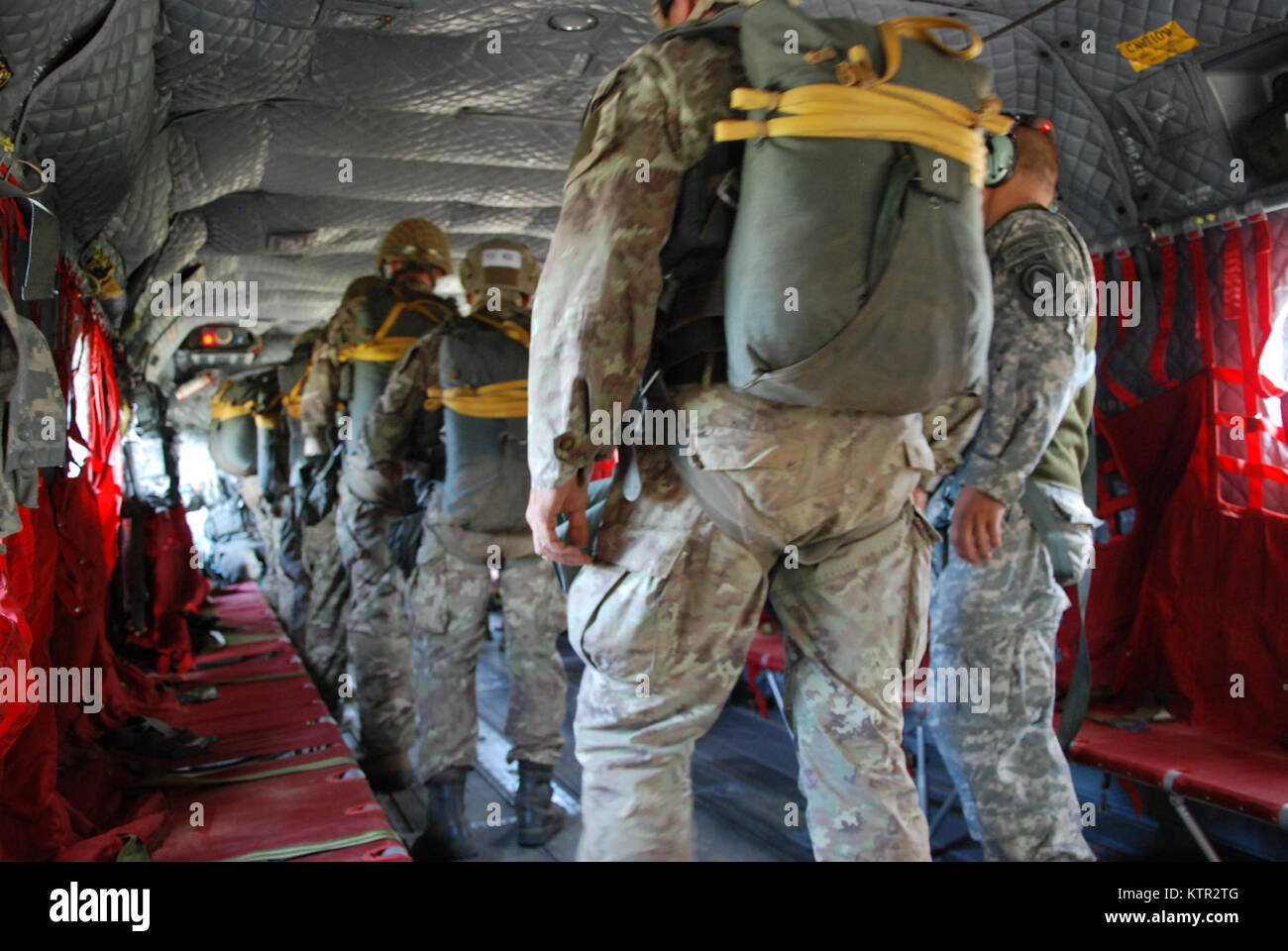 U.S. Army and Partner Nation Paratroopers jump from a  CH-47 F Chinook Helicopter operated by the New York Army National Guard's Co. B 3rd Battalion 126th Aviation during Leapfest 2016 at the University of Rhode Island, West Kingston, R.I., August 6, 2016. Leapfest is the largest, longest standing, international static line parachute training event and competition hosted by the 56th Troop Command, Rhode Island Army National Guard to promote high level technical training and esprit de corps within the International Airborne community.The New York Army National Guard aircraft was one of four pro Stock Photo