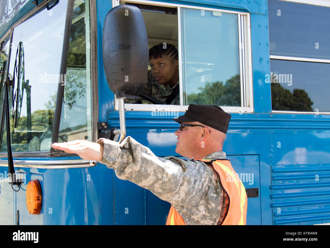 New York Guard Sgt. Robert Freeman, gives directions to a bus driver at