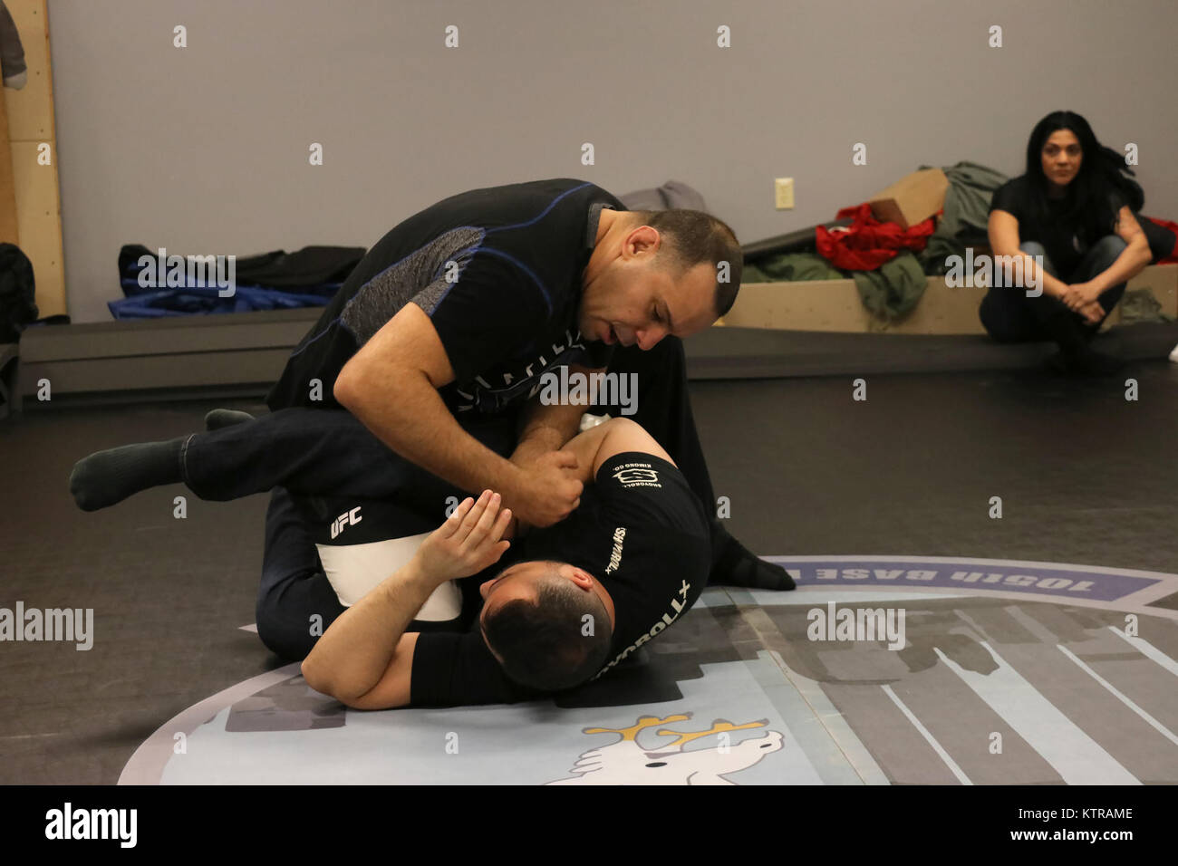 Luigi Mondelli, Brazilian Jiu Jitsu 4th degree black belt, demonstrates ground control and handcuffing techniques on Brazilian Jiu Jitsu brown belt Marcos Borges at Stewart Air National Guard Base, NY, on March 4, 2017. Instructors from American Top Team in Conneticut travel to Stewart Air National Guard Base to teach real-life self defense tactics to Air National Guardsmen. (U.S. Air National Guard photo by Master Sgt. Lee Guagenti) Stock Photo