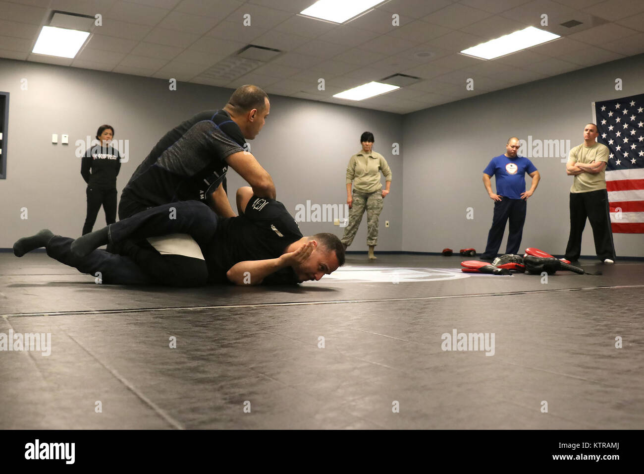 Luigi Mondelli, Brazilian Jiu Jitsu 4th degree black belt, demonstrates ground control and handcuffing techniques on Brazilian Jiu Jitsu brown belt Marcos Borges at Stewart Air National Guard Base, NY, on March 4, 2017. Instructors from American Top Team in Conneticut travel to Stewart Air National Guard Base to teach real-life self defense tactics to Air National Guardsmen. (U.S. Air National Guard photo by Master Sgt. Lee Guagenti) Stock Photo
