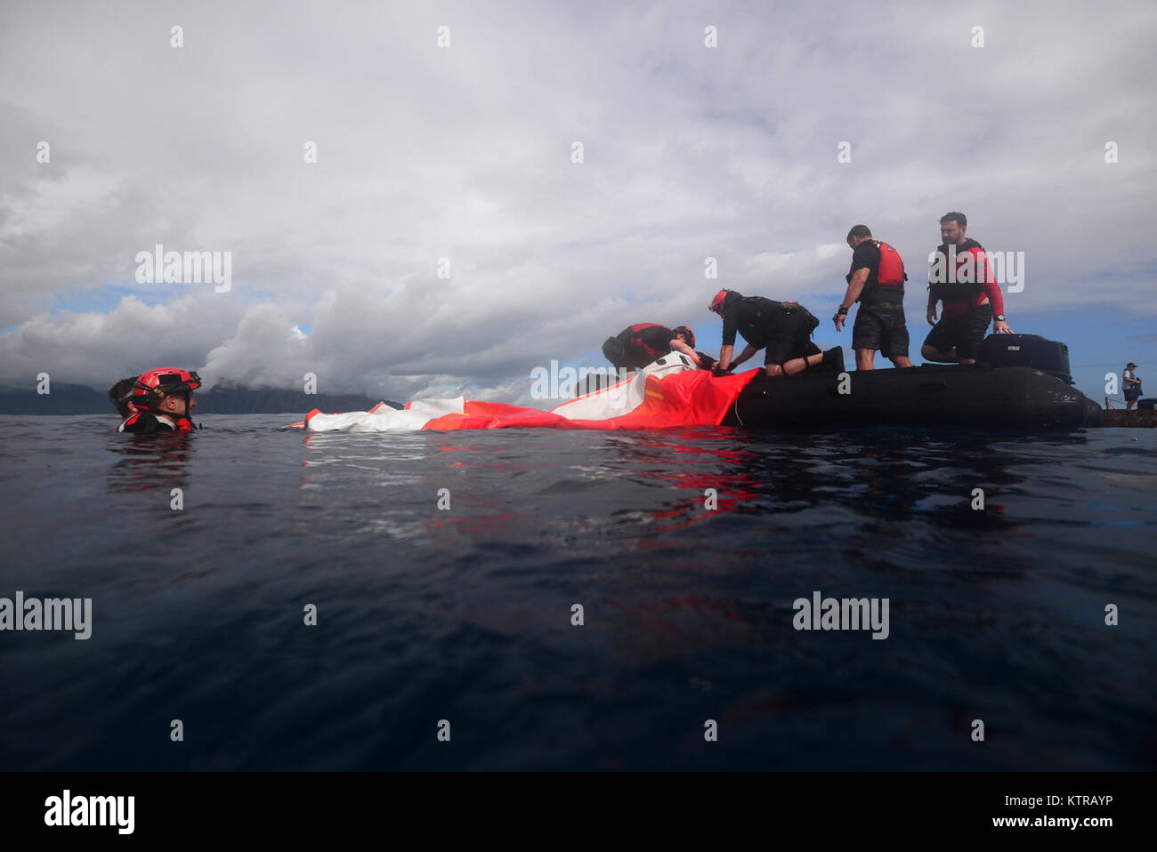 The "Front Porch" flotation device is unfolded and inflated by Pararescuemen and Combat Rescue