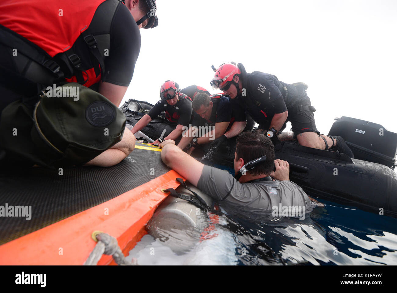 The "Front Porch" flotation device is unfolded and inflated by Pararescuemen and Combat Rescue