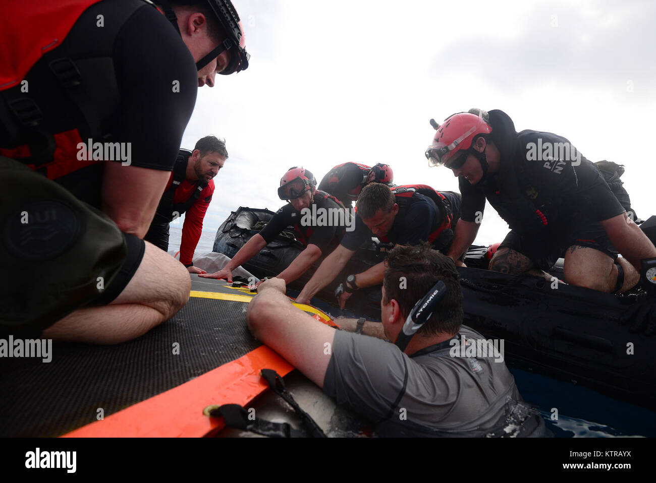 The "Front Porch" flotation device is unfolded and inflated by Pararescuemen and Combat Rescue