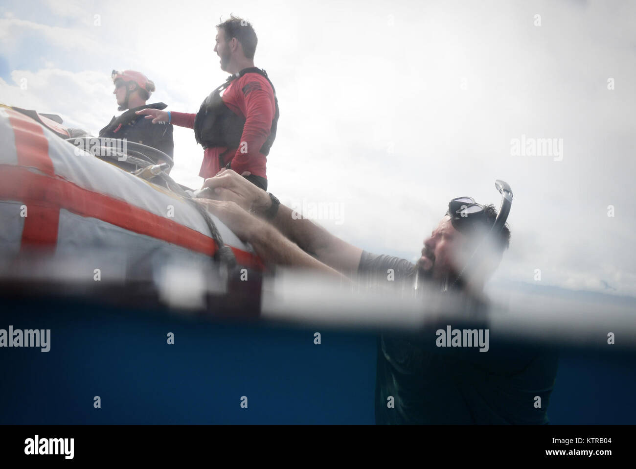 The "Front Porch" flotation device is unfolded and inflated by Pararescuemen and Combat Rescue