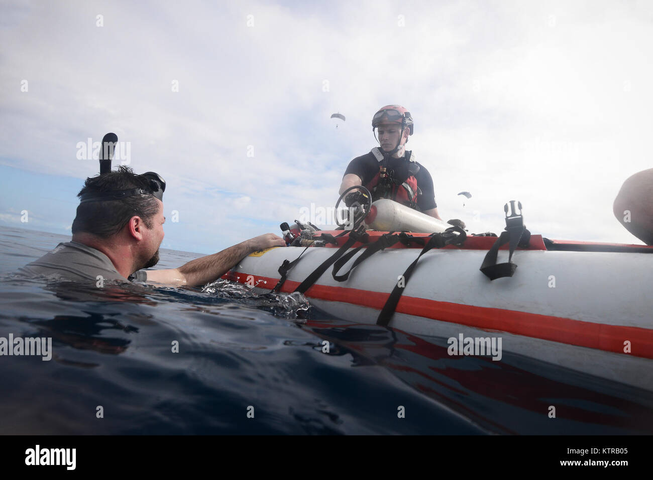 The "Front Porch" flotation device is unfolded and inflated by Pararescuemen and Combat Rescue