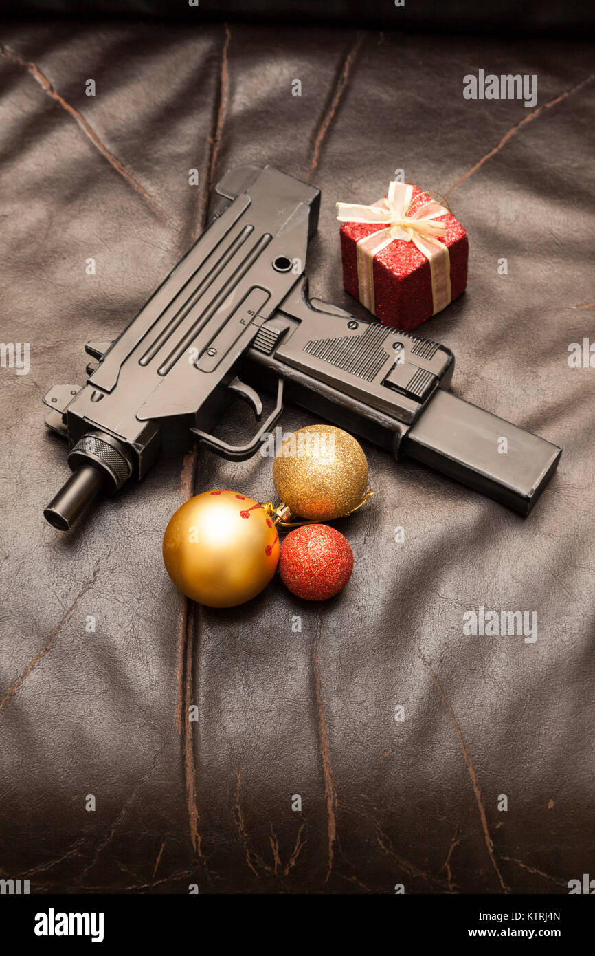 An Micro Uzi 9mm semi automatic pistol handgun with Christmas decorations Stock Photo