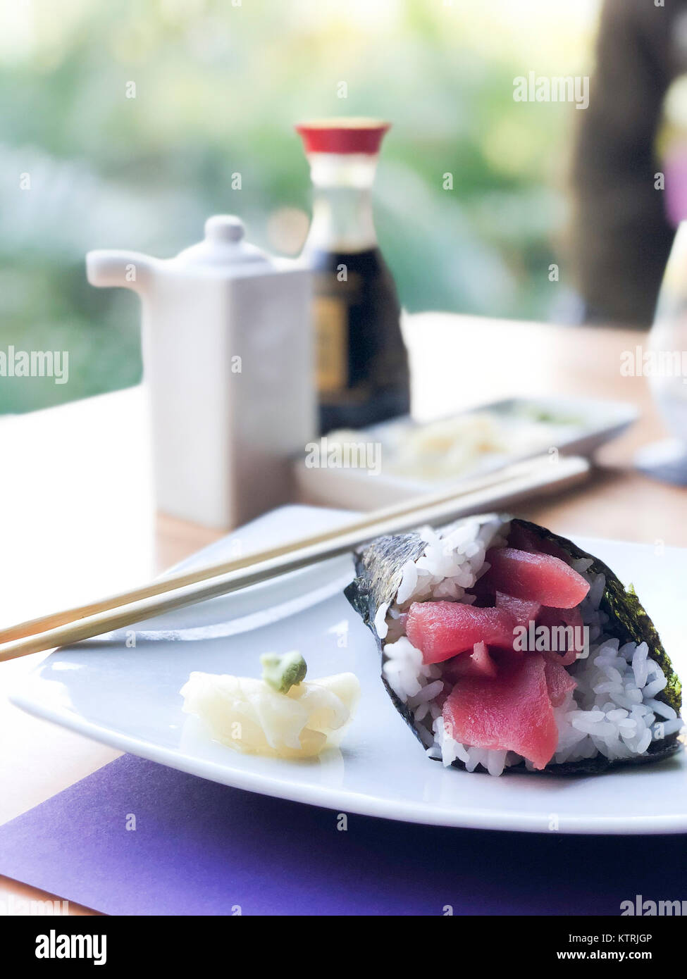Tuna sushi handroll with sliced ginger and wasabi Stock Photo