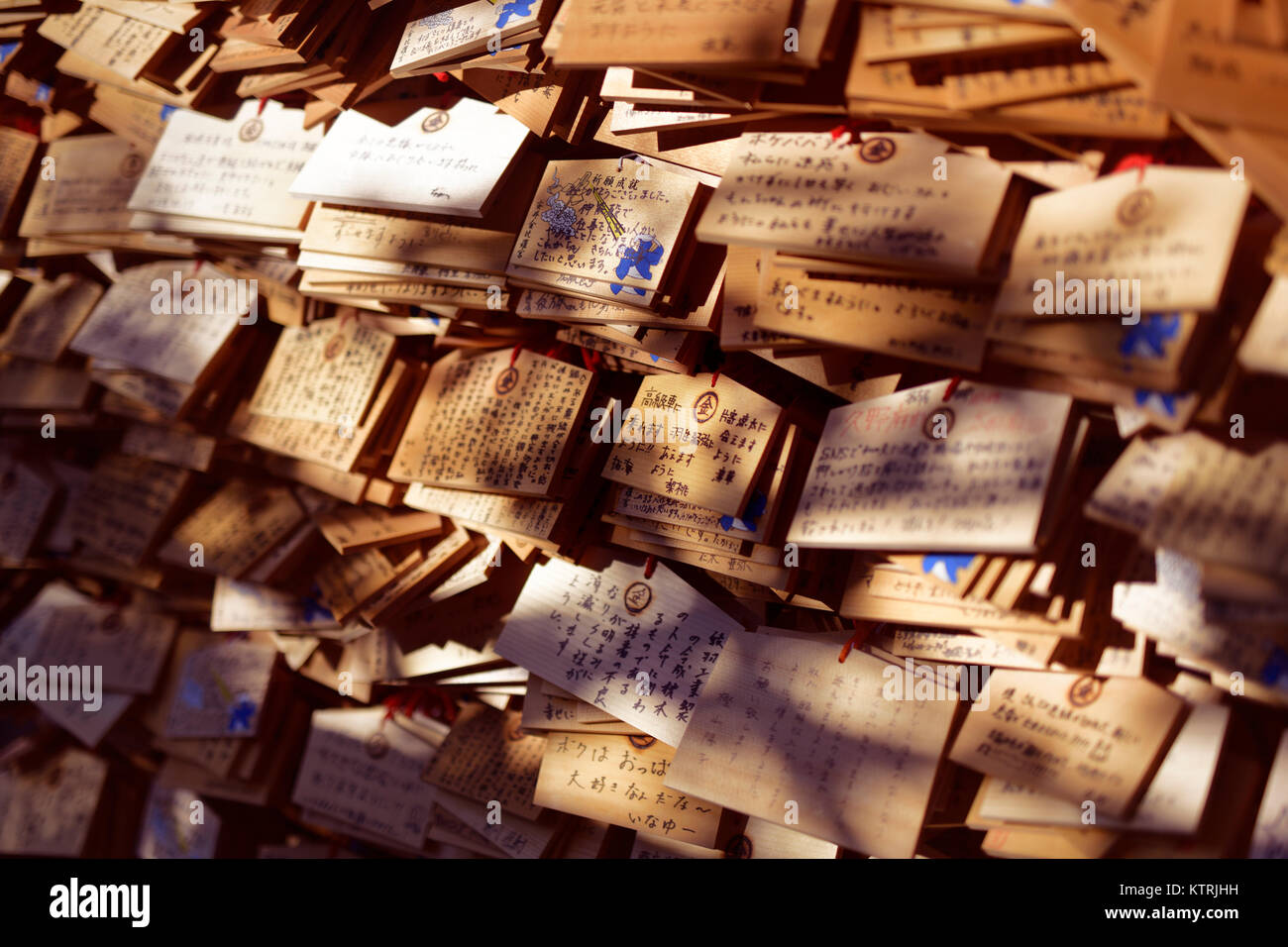 Artistic photo of Ema, Japanese wooden votive plates with written prayers and wishes, hanging at a Shinto shrine in Kyoto, Japan for Kami spirits to r Stock Photo