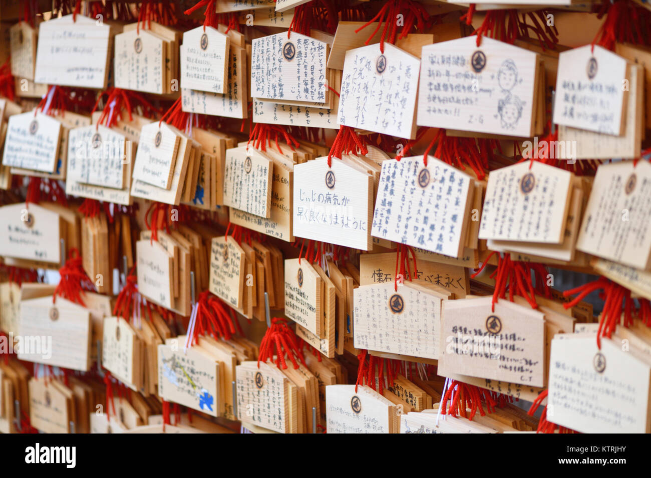 Ema, Japanese wooden wishing plaques with prayers and wishes written on them, hanging at a Shinto shrine in Kyoto, Japan. Stock Photo