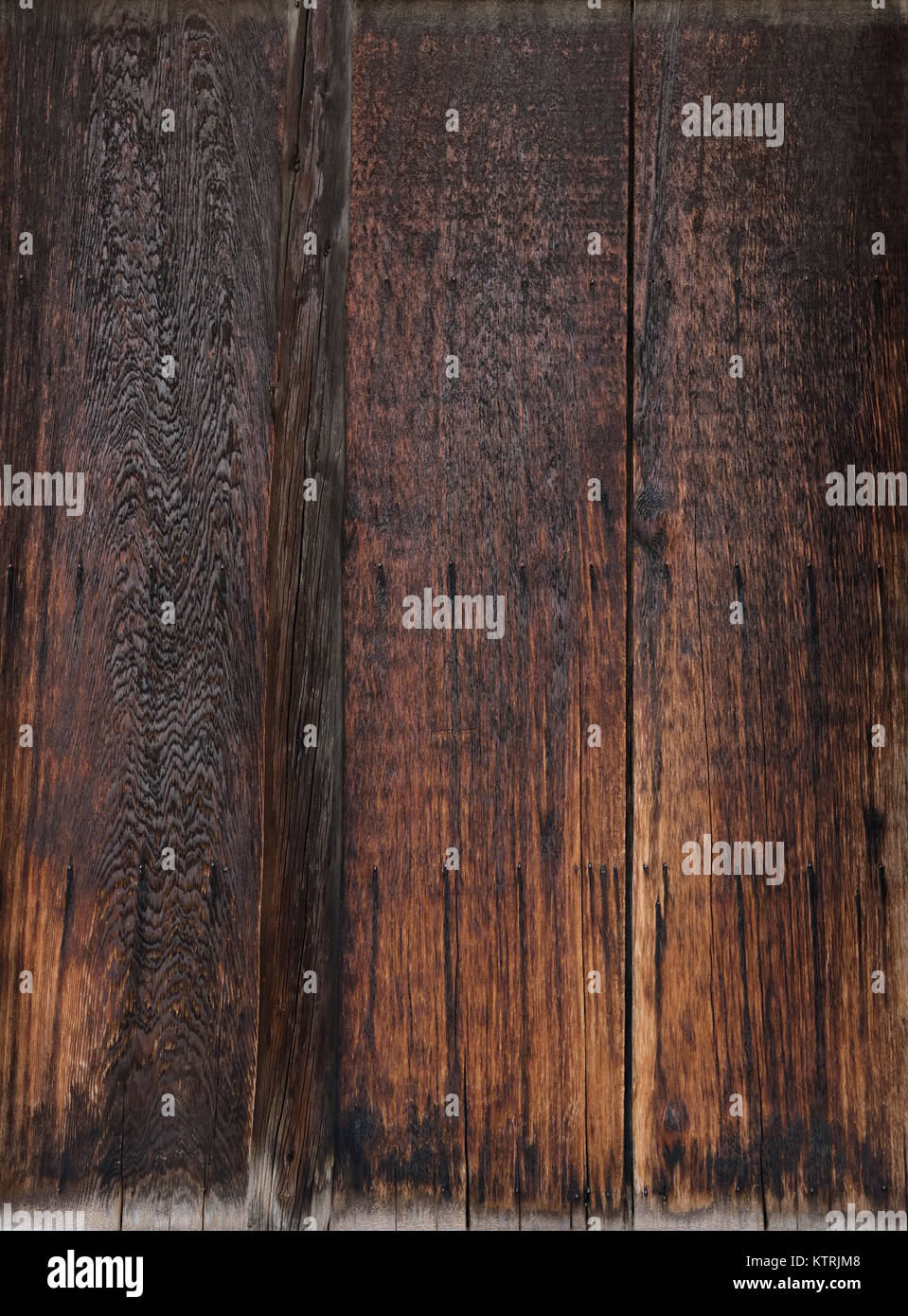 Closeup of charred dark brown wooden boards, abstract texture background. Stock Photo