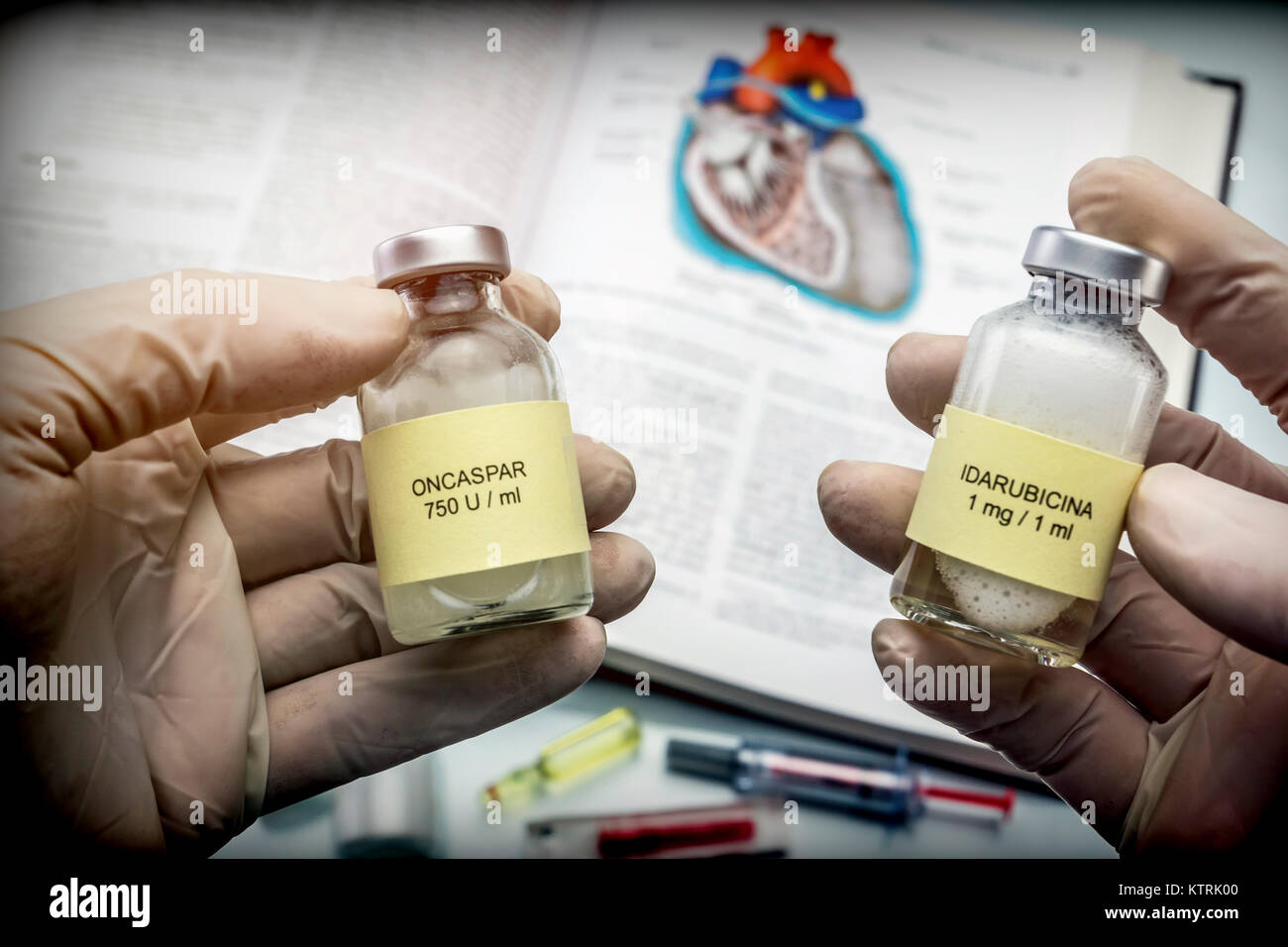 Doctor holds two vials of idarubicina and Oncaspar to inject, medicine used in acute lymphatic leukemia disease Stock Photo