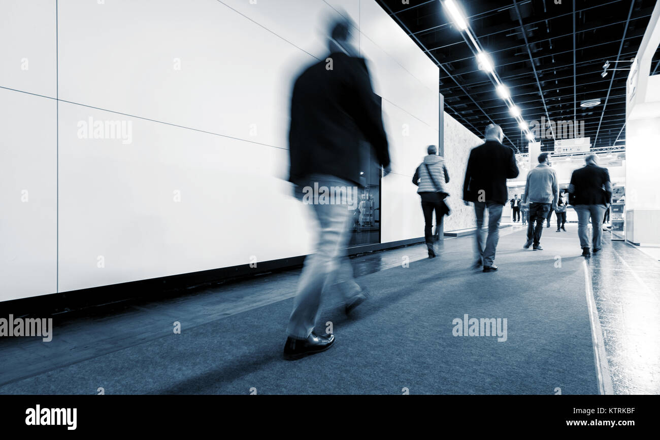 Blurred business people at a trade fair Stock Photo - Alamy