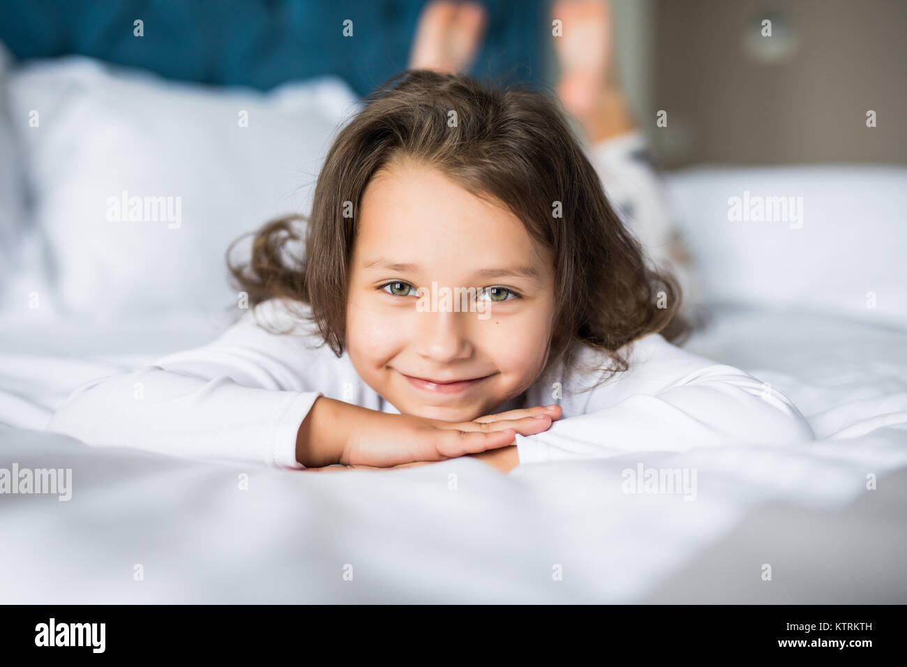 Cute little girl in pajamas on the bed in the morning Stock Photo - Alamy