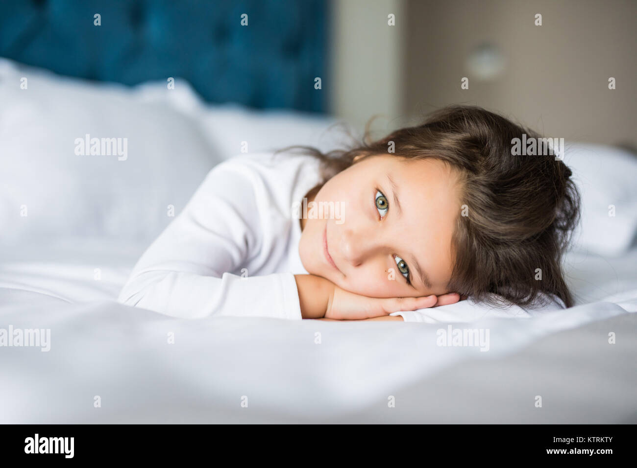Cute little girl in pajamas on the bed in the morning Stock Photo - Alamy