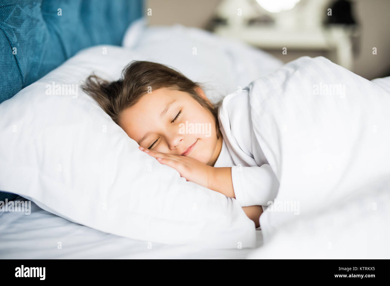 Sweet little girl is sleeping in her bed at home Stock Photo - Alamy