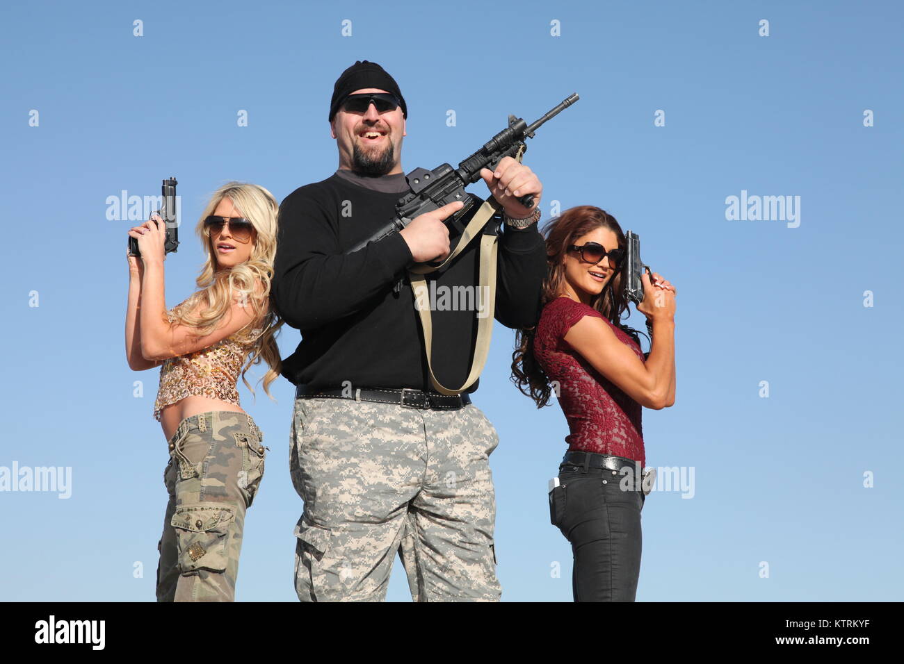 World Wrestling Entertainment (WWE) stars (L-R) Eve Torres, Paul Wright and Barbara Blank pose for photos at the Kandahar Airfield during a USO Tour December 3, 2010 near Kandahar City, Afghanistan. Stock Photo