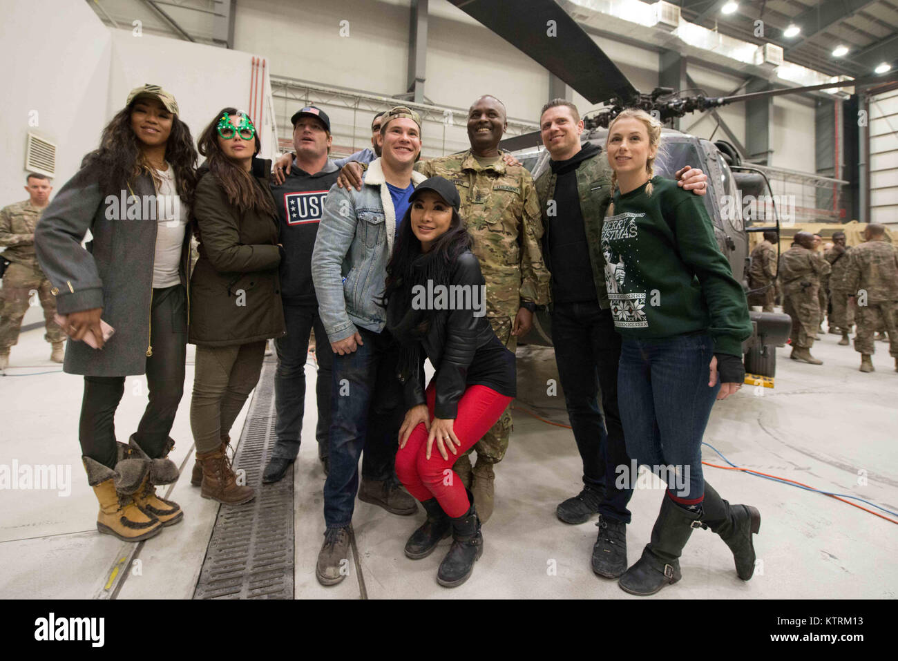 World Wrestling Entertainment (WWE) wrestler Alicia Fox, country music singer Jerrod Niemann, actor Adam Devine, wrestlers Gail Kim and and The Miz (Michael Mizanin), and comedian Iliza Shlesinger pose for a group photo during the USO Holiday Tour at the Bagram Airfield December 24, 2017 in Bagram, Afghanistan. Stock Photo