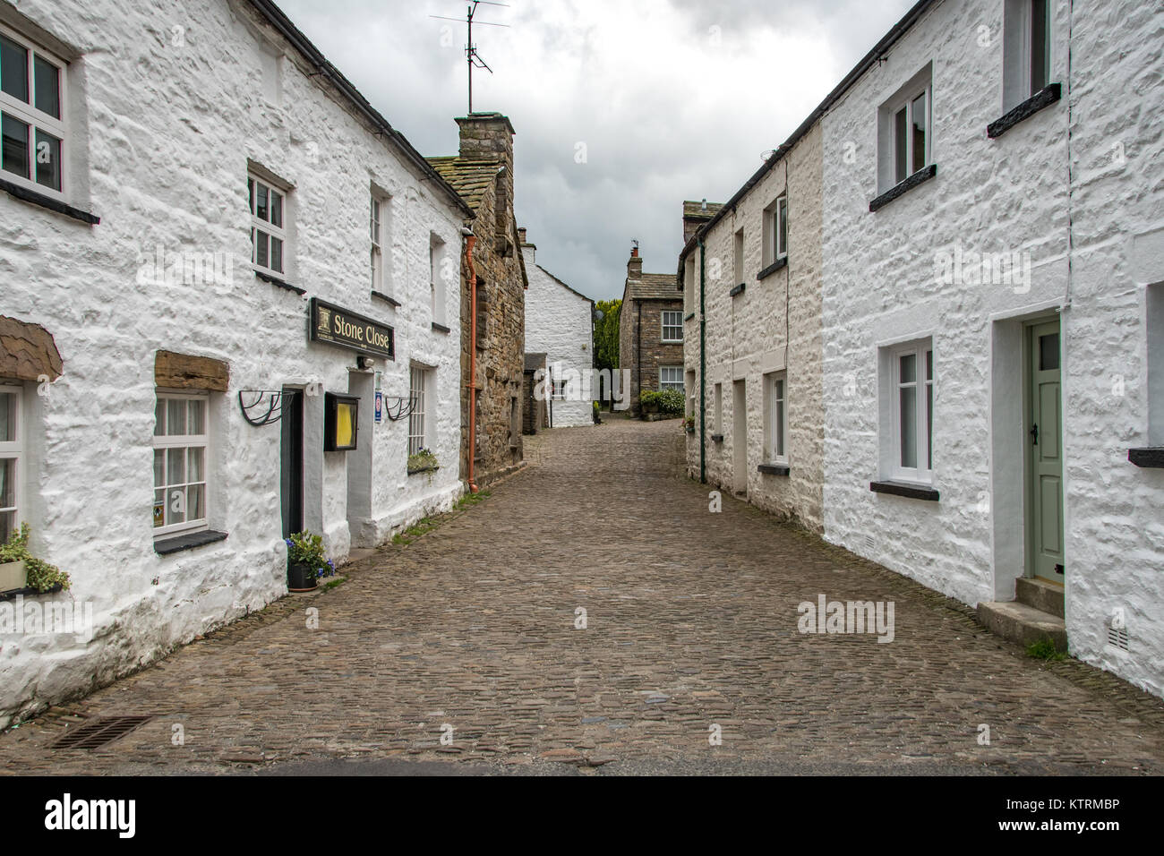 Street lined with quaint stone houses, Dent, Yorkshire, England Stock
