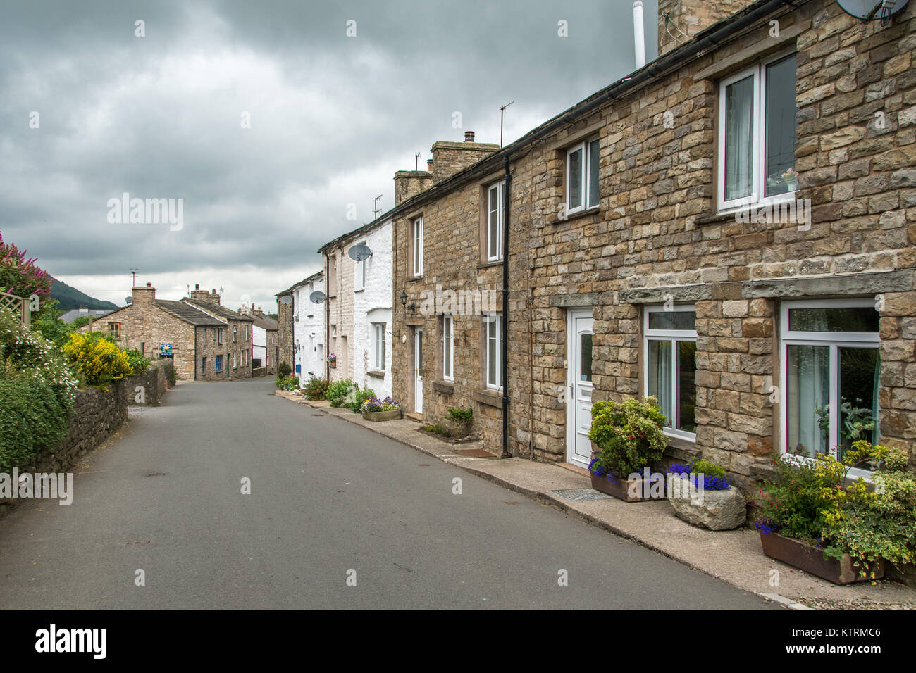 Street lined with quaint stone houses, Dent, Yorkshire, England Stock