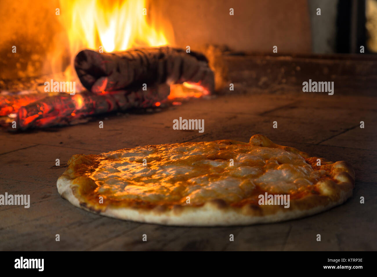 Pizza cooking in a tradition firewood oven Stock Photo Alamy